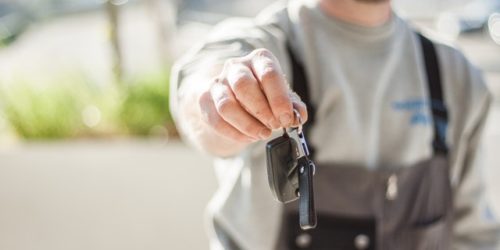 selling used car trade in man handing over keys after used car trade in